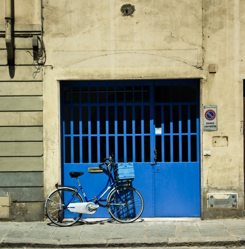 Blue bike and garage in Florence Italy
