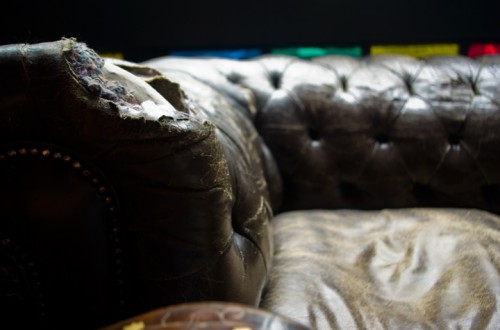 Worn couch inside pub in London, UK